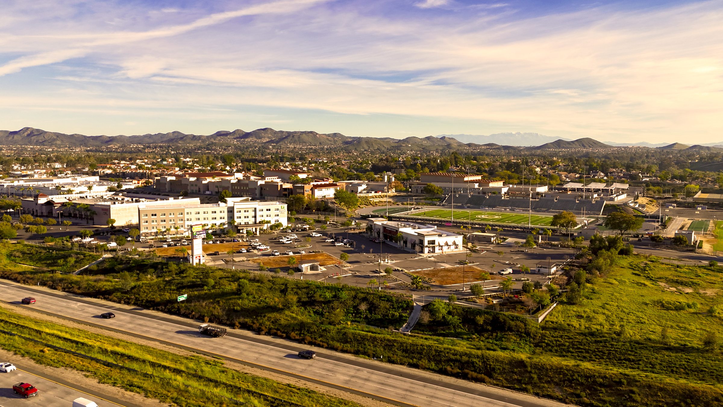 Aerial view of a graded land development site at golden hour